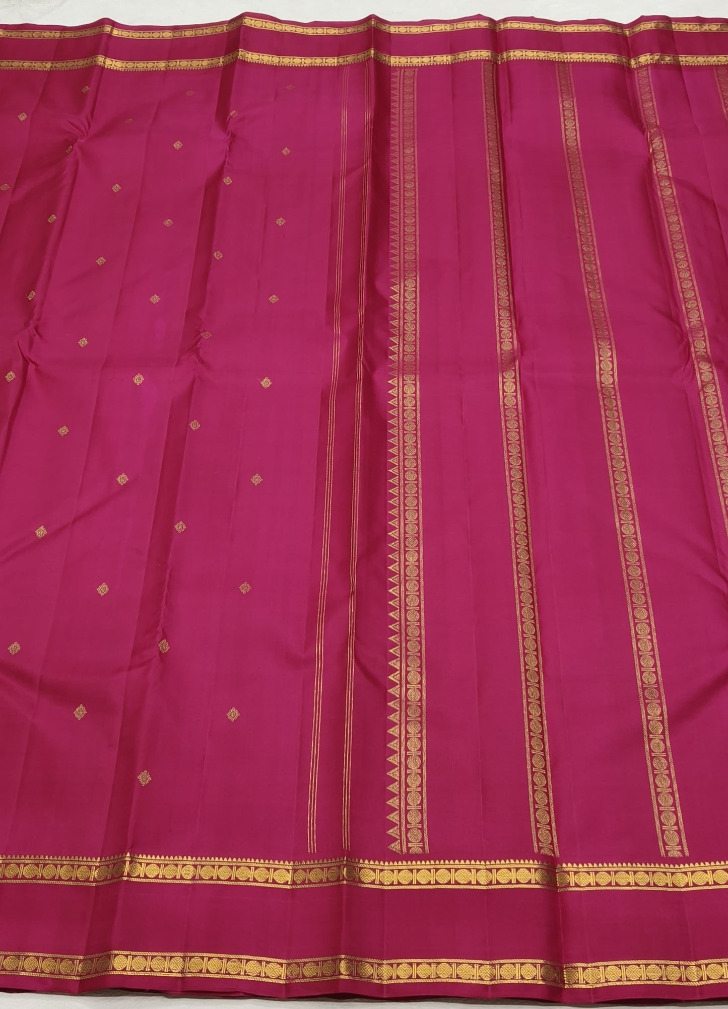 Raspberry pink Kanchipattu silk saree with traditional zari weaving detail