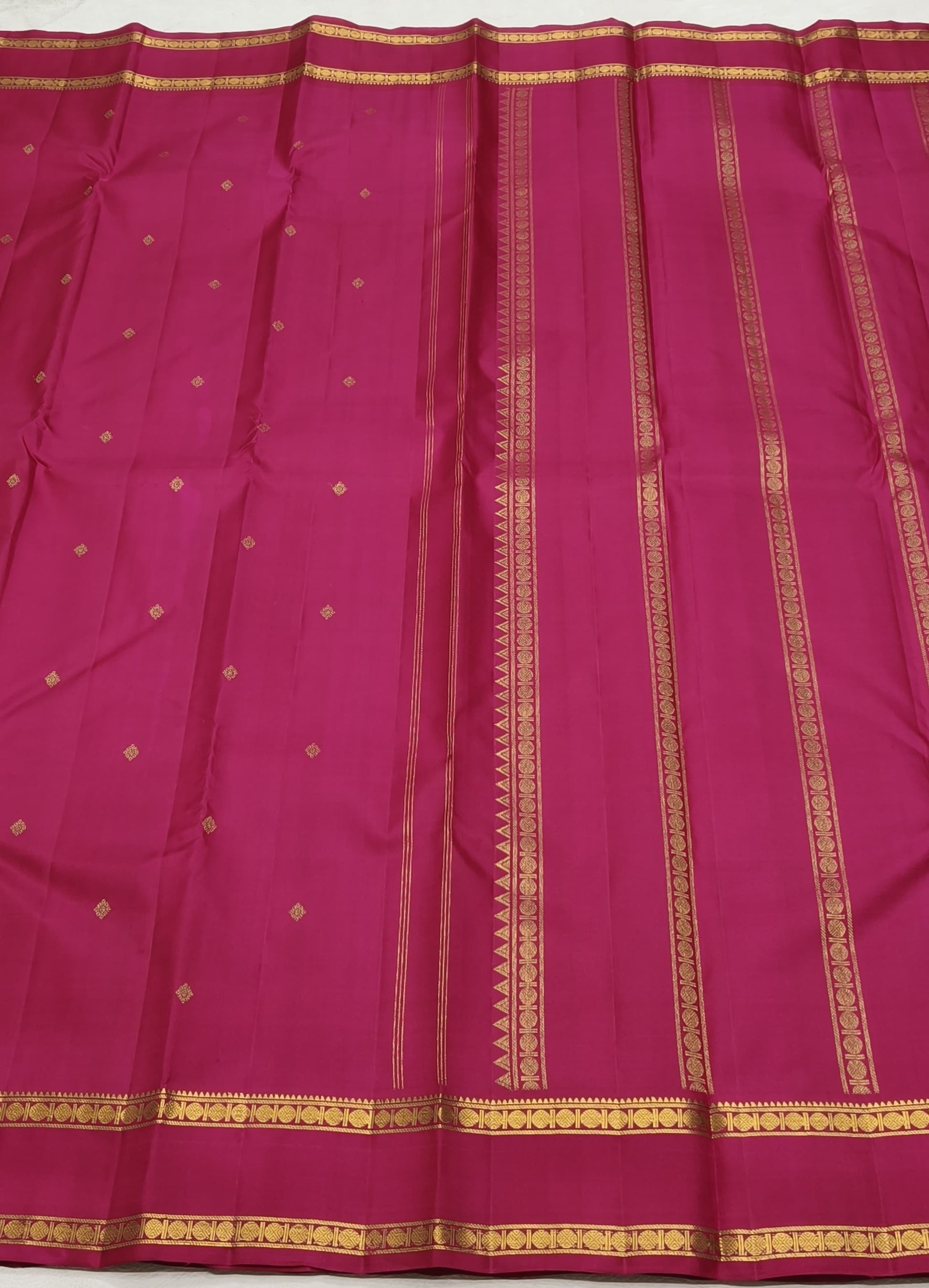 Raspberry pink Kanchipattu silk saree with traditional zari weaving detail