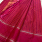 Close-up of gold zari buttas in the 1000 Butta pattern on the raspberry pink KanchiPattu saree.