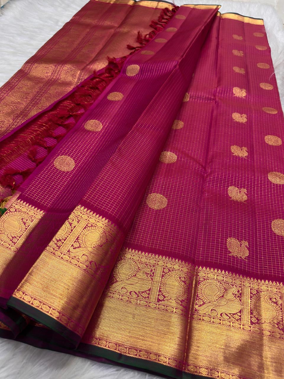Raspberry pink pure silk Kanchipuram zari kattam saree, with ornate Mayil Chakram buttas and broad gold border