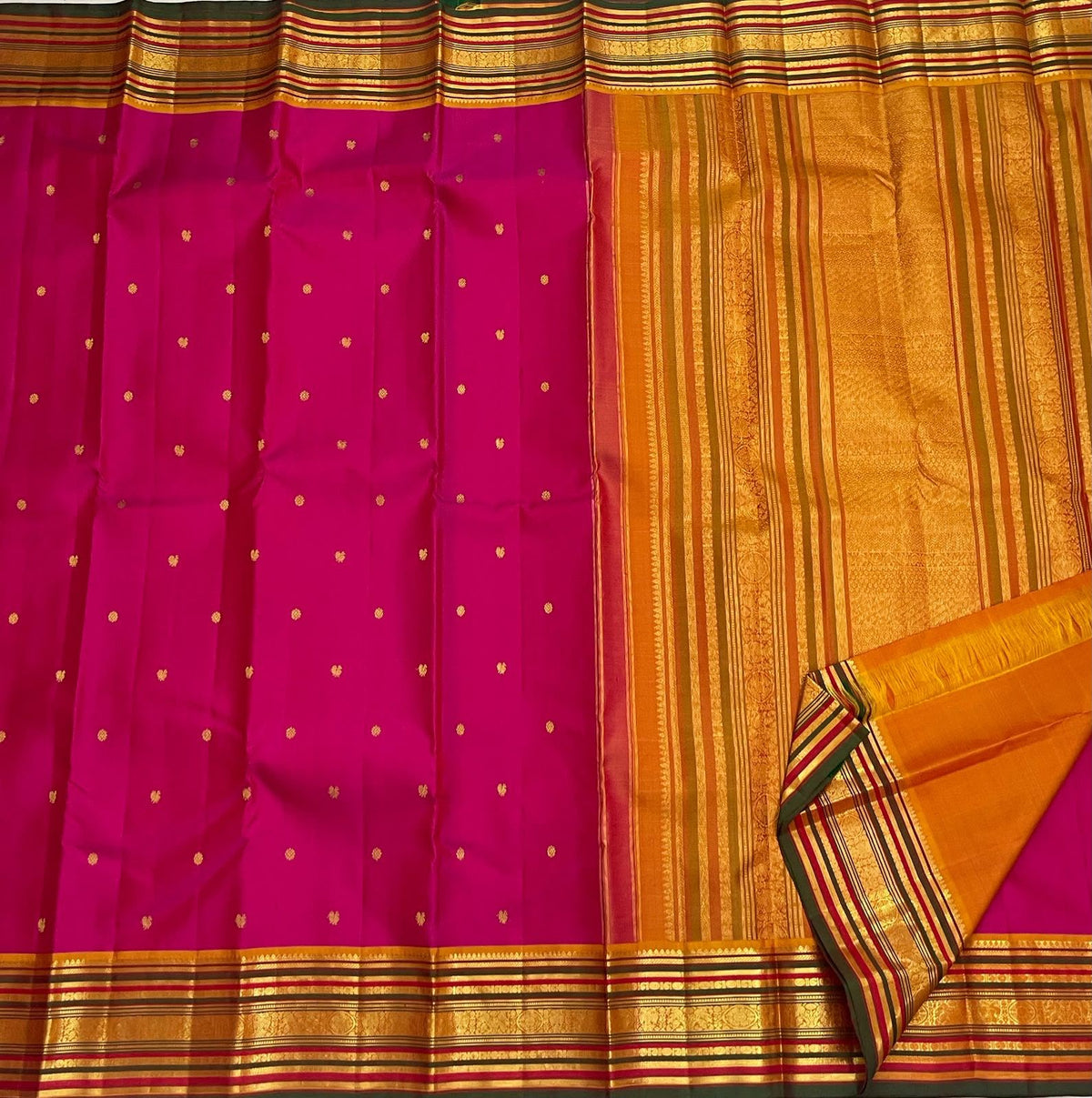 Handwoven pink Kanjivaram saree with delicate antique gold zari buttas