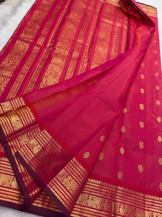 Raspberry pink KanchiPattu silk saree — traditional gold zari floral motif detail on the body