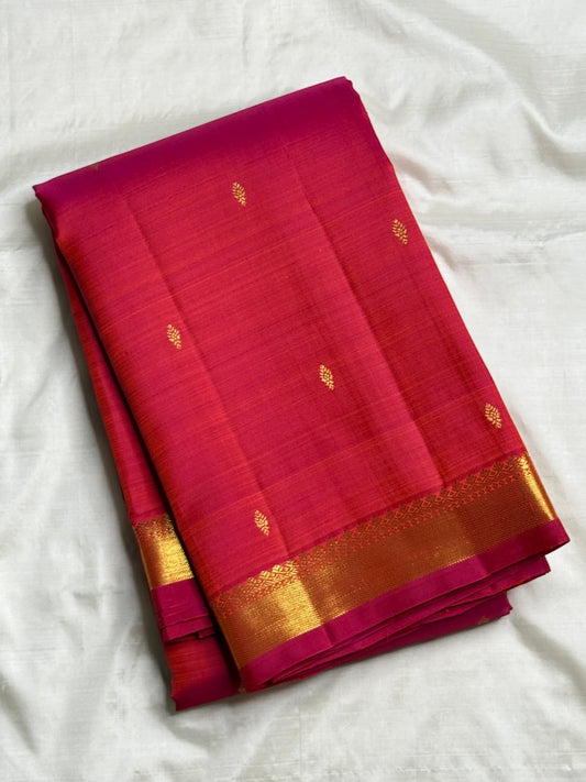 Rani Pink Kanchipuram Butta saree folded showing petite gold zari motifs and border