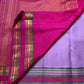Raspberry Pink contrast border with multiple gold zari registers on Lavender Kanchipuram silk saree.