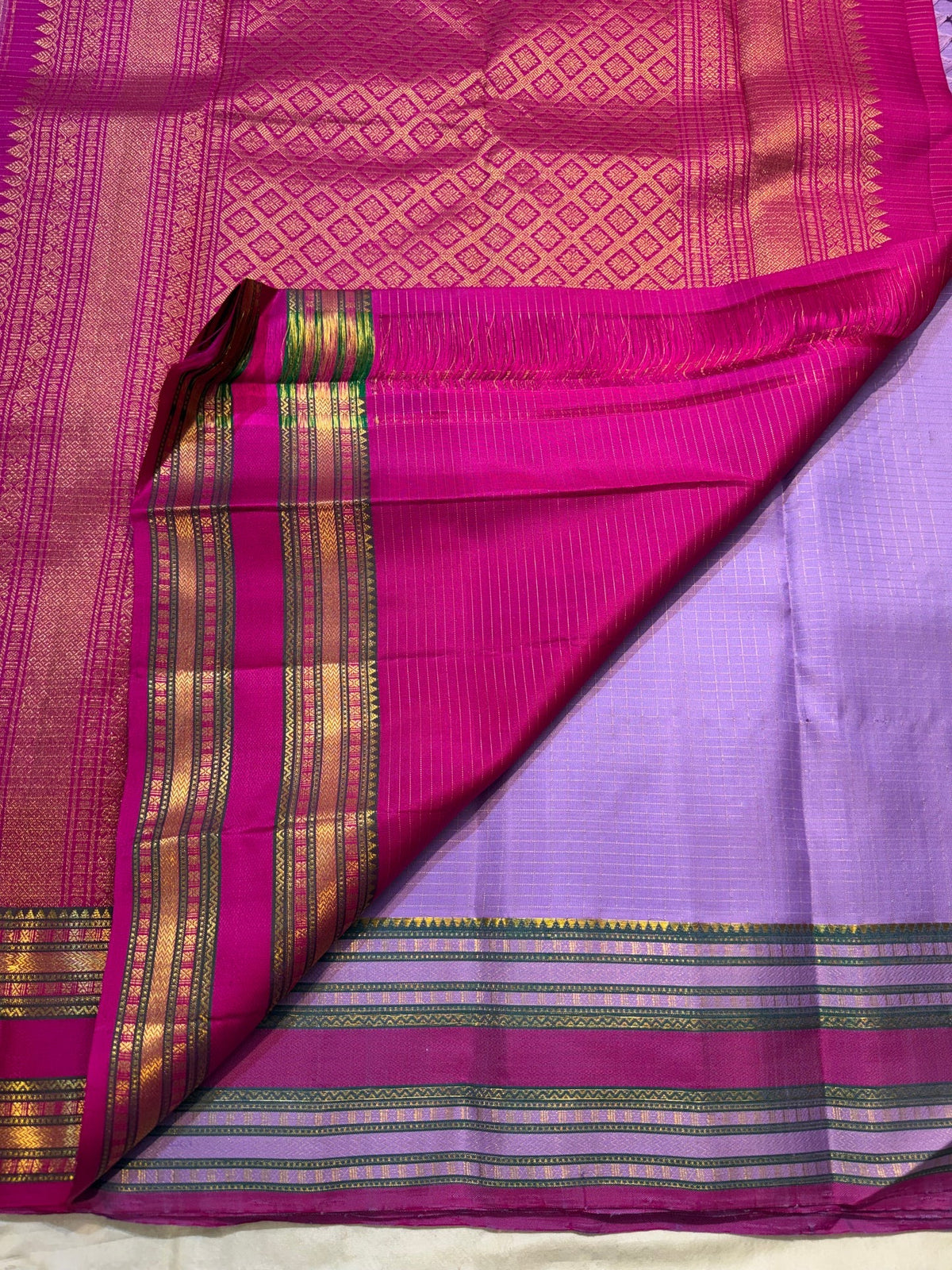 Raspberry Pink contrast border with multiple gold zari registers on Lavender Kanchipuram silk saree.
