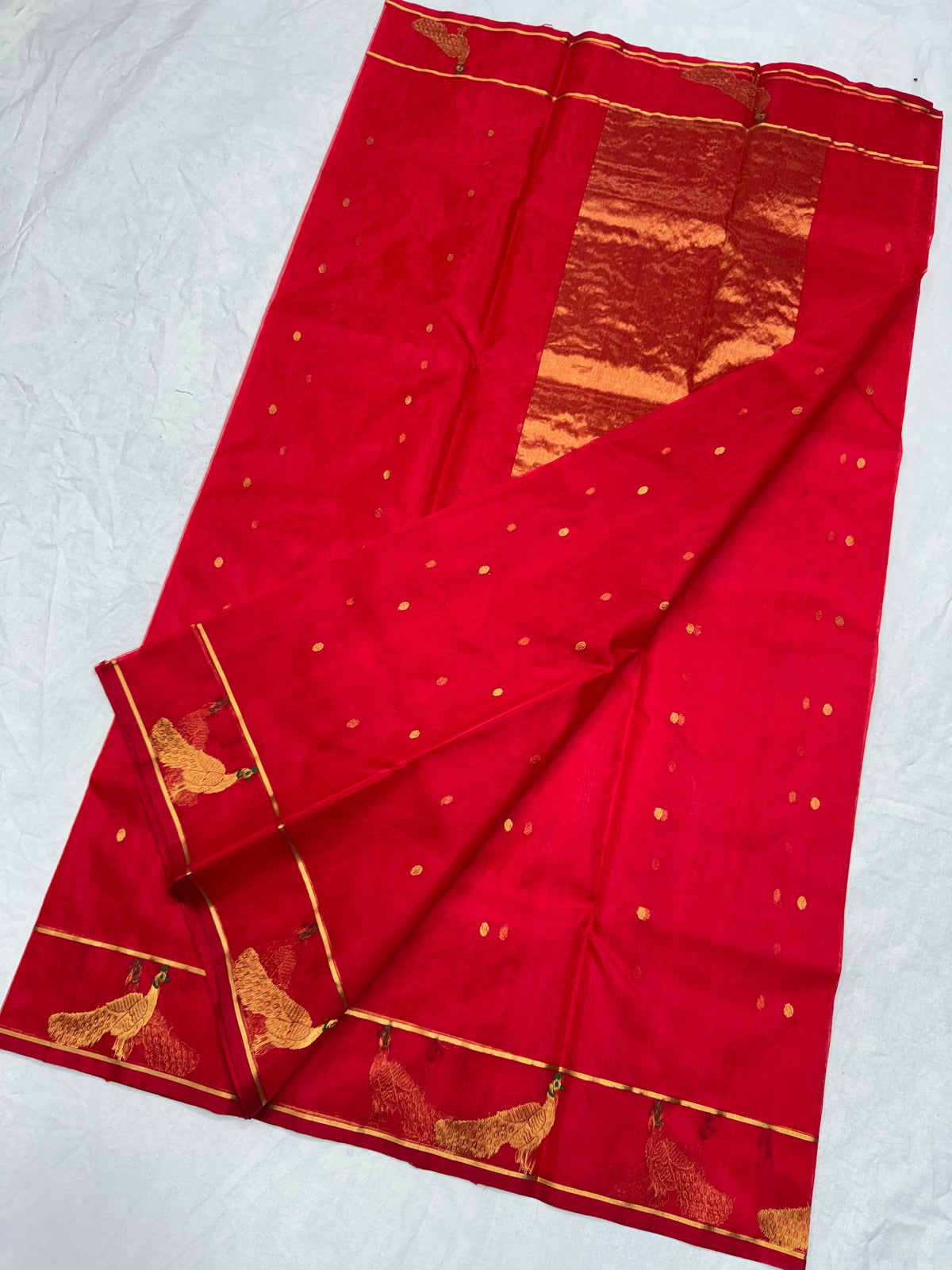 Raspberry red Chanderi silk saree showing peacock motif border with fine gold-toned zari and green detailing