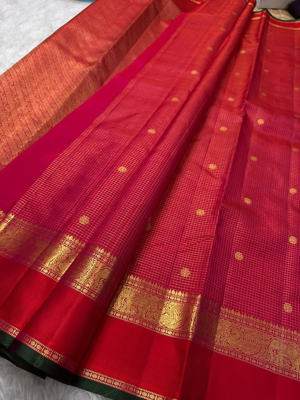 Raspberry-red Pure Silk Kanchipuram saree showing the traditional gold Zari Kattam weave.