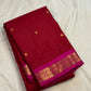 Close-up of gold zari butta motifs on deep crimson Kanjeevaram pure silk saree