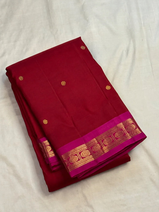 Close-up of gold zari butta motifs on deep crimson Kanjeevaram pure silk saree