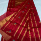 Raspberry red handloom Pattu Silk Chanderi saree folded with turquoise floral buttas and fine gold-toned zari border