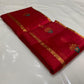 Draped raspberry red handloom Chanderi silk saree showing fine gold-toned stripes and turquoise floral buttas