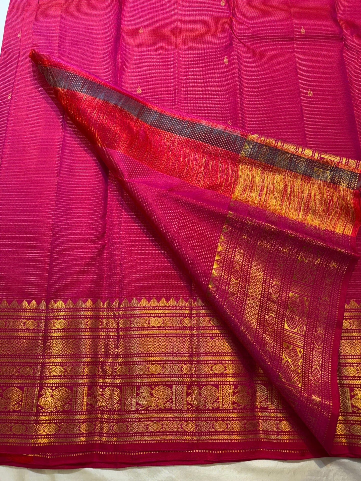 Raspberry red and pink shot silk body with fine continuous Vairaoosi zari lines.