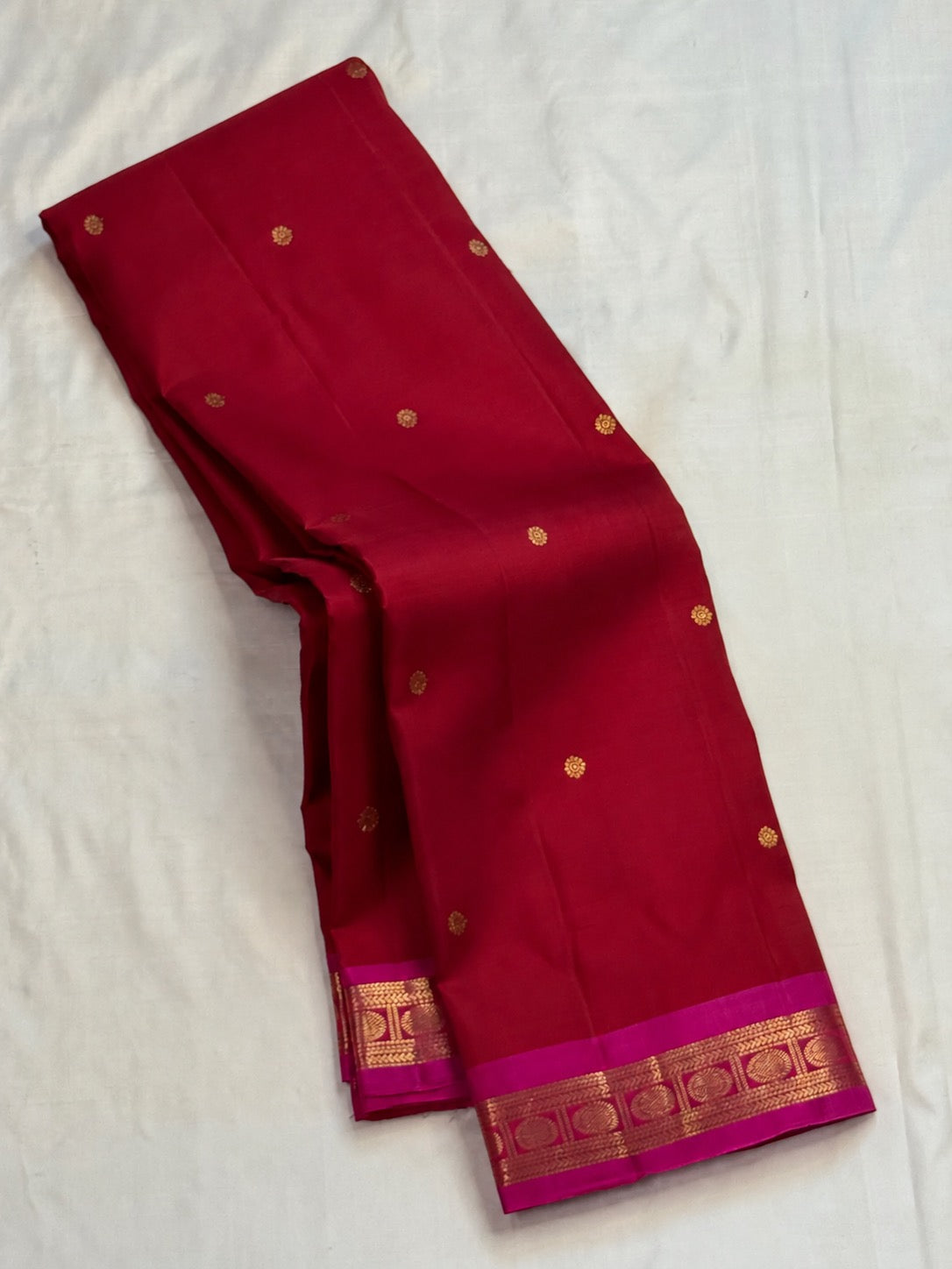 Deep crimson handwoven pure silk Kanjeevaram saree with gold zari butta and rani pink zari border, full view
