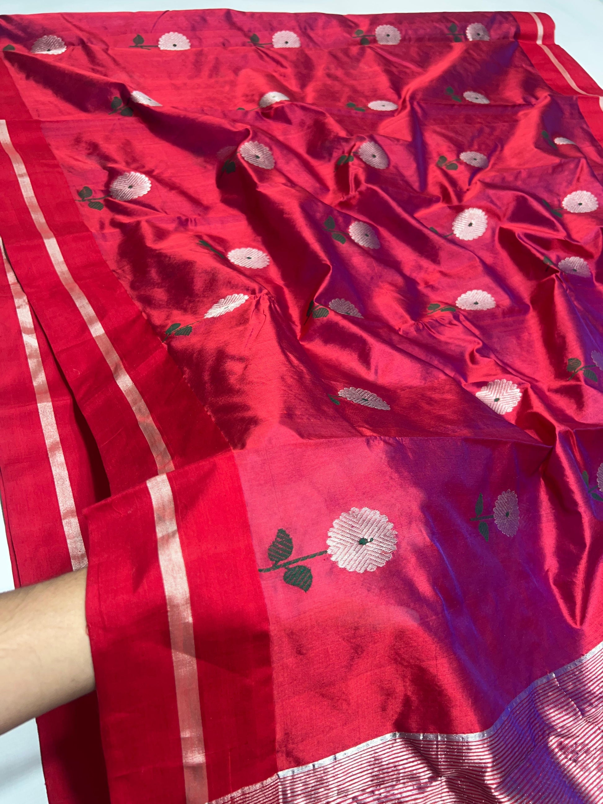 Raspberry Red handloom Chanderi saree draped, showing silver floral buttas across the Pattu Silk body