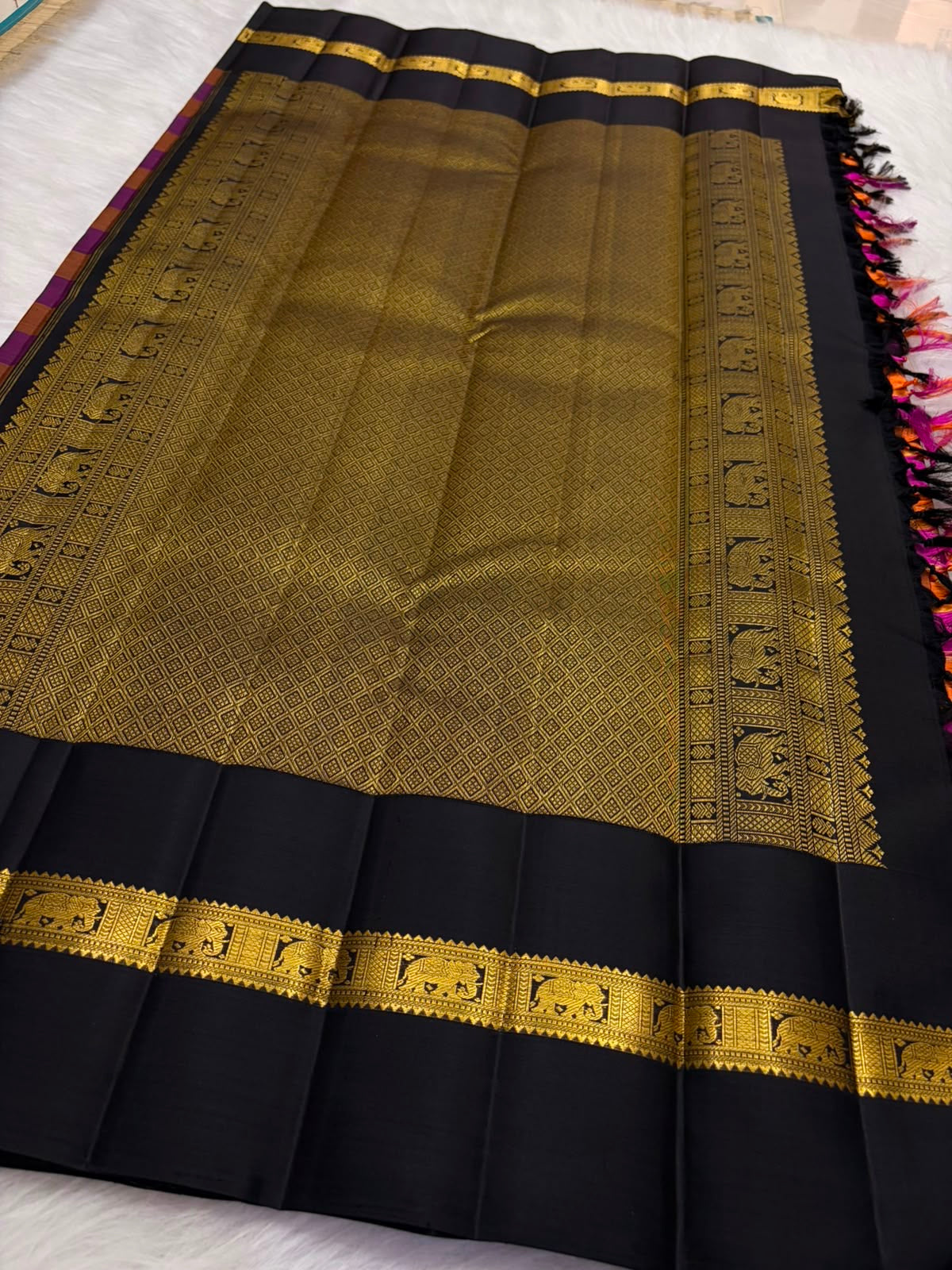 Raspberry pink and rust orange Kancheepuram silk saree — gold zari checked body close-up