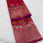 Folded red Chanderi silk saree showing deer and palm-tree zari border with chevron detailing