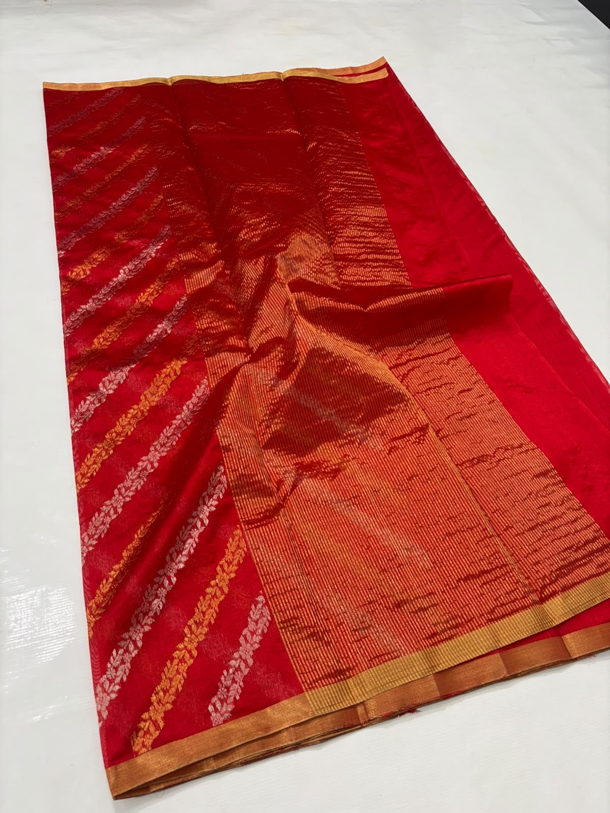Close view of Vermilion Red Chanderi silk saree with wavy woven stripes and gold-toned edging