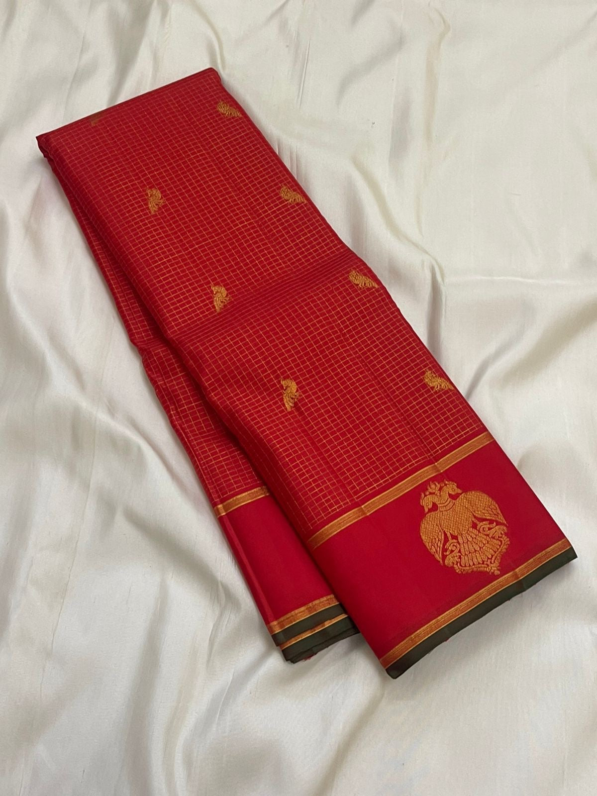 Long folded red checked pure Kanchipuram silk saree with small gold zari buttas and Gandaberunda motif border