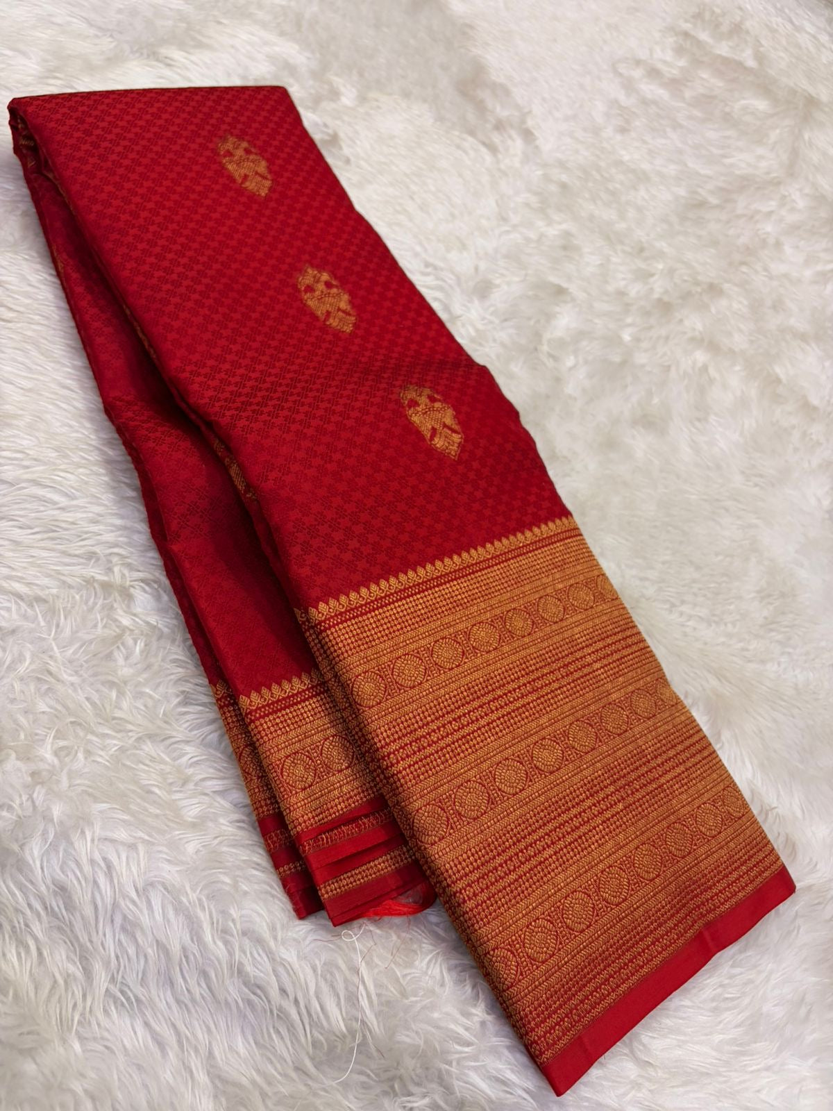 Ornate self-colour red border with dense antique gold zari multi-band floral and geometric motifs