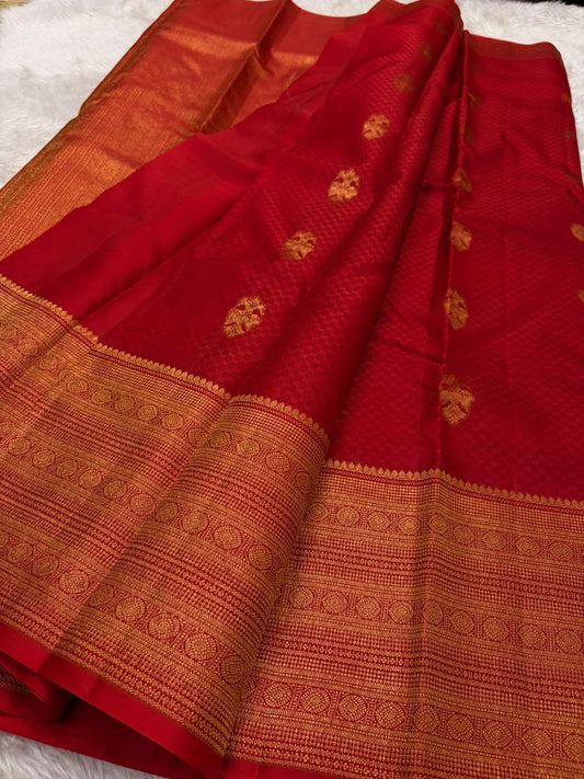 Red Kanjeevaram saree folded to show Paimadi Kattam body texture and Gandaberunda butta motifs