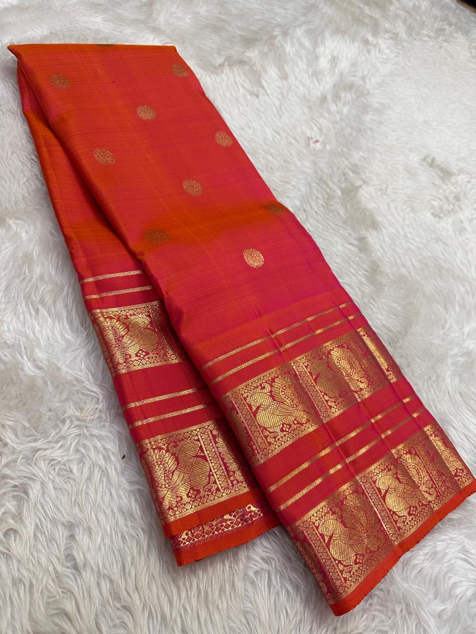 Kanjivaram silk saree in vermilion red with gold border Mayil Butta weave draped view