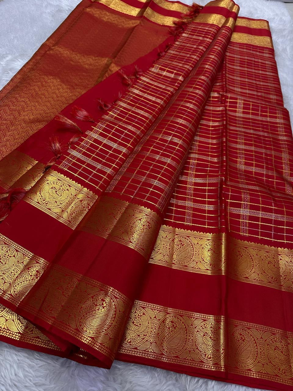 Open Crimson Red Pure Silk Kanchipuram saree with gold Zari Kattam checks and a richly woven Sorgavasal Mayil and Manga border.