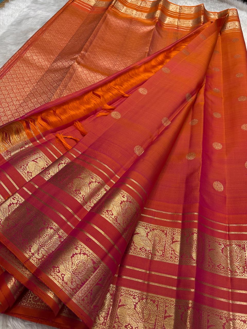 Kanchipuram silk saree in vermilion red with gold border Mayil Butta weave folded view