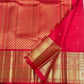 Close view of petite handwoven zari buttas across radiant Vermilion Red Kanjivaram silk.