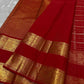 Close view of Crimson Red Kanchipuram silk with a broad gold zari Sorgavasal Mayil and Manga border and richly woven pallu.