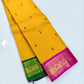 Close view of alternating Arakku-red and green buttas on the yellow silk body