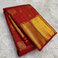 Pillar box red Kancheepuram saree with grand antique-gold zari border, close view