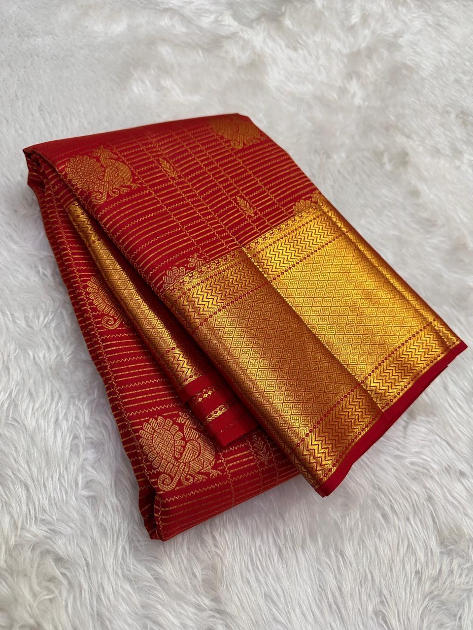 Pillar box red Kancheepuram saree with grand antique-gold zari border, close view