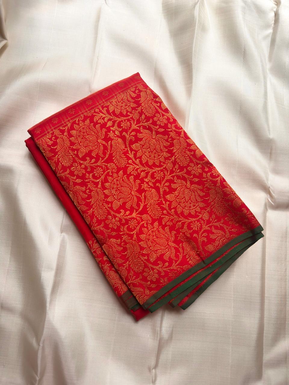 Dense floral gold zari jaal with closely woven flowers and curling vines on a red Pure Silk Kancheepuram saree.
