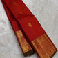 Red oosi kattam Kanchipuram silk saree drape showing zari woven border with green edge