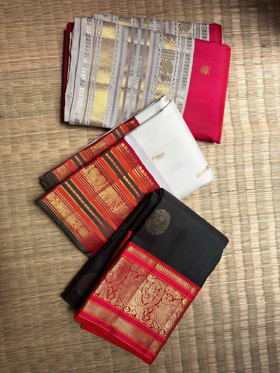 Crimson Kanchipuram Varisaipet saree, silver-grey border with gold zari motifs detail