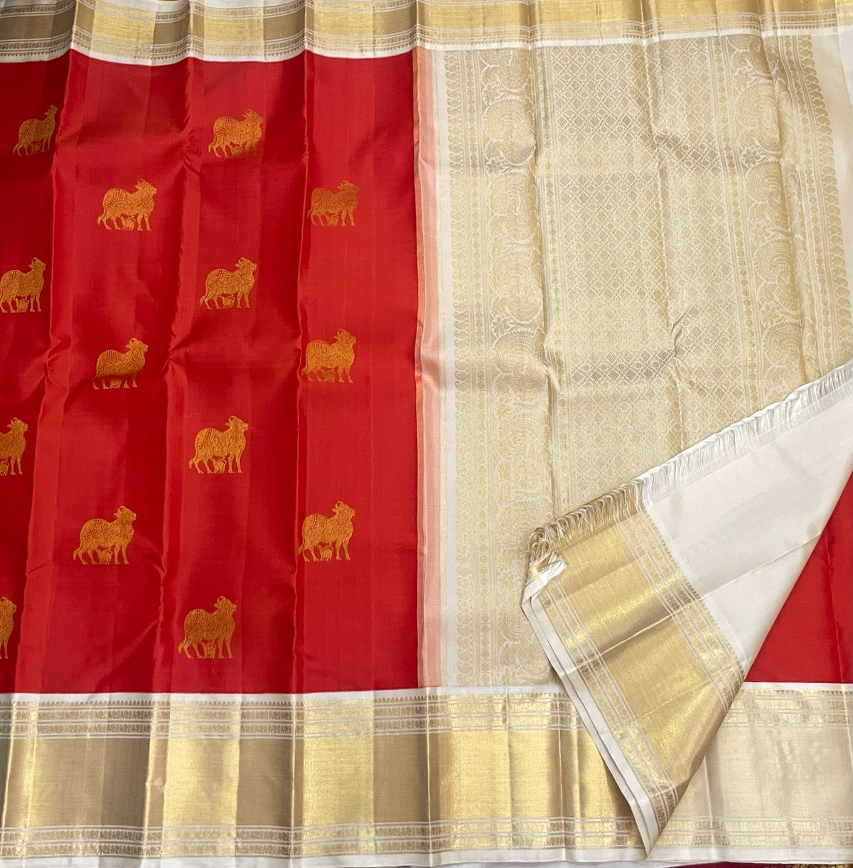Handwoven red Kanchipuram silk saree with 2-gram antique gold zari cow motifs
