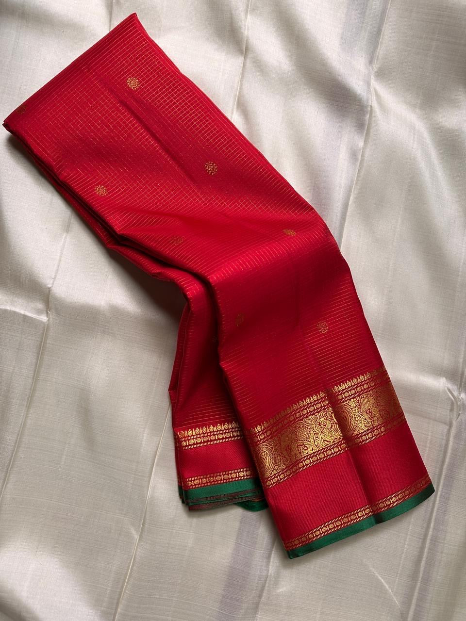 Close textile view of Sindoor red Zari Kattam body with delicate gold lattice and spaced buttas