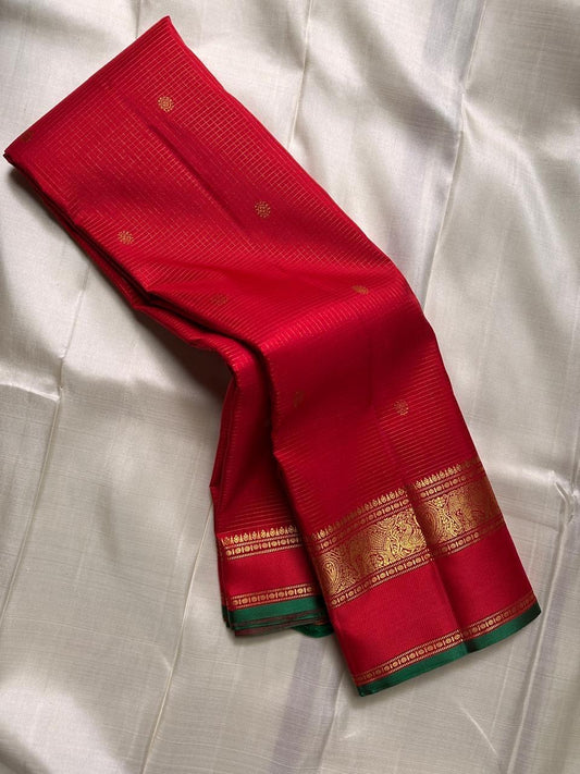 Close textile view of Sindoor red Zari Kattam body with delicate gold lattice and spaced buttas