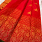 Individually woven perched-bird gold zari buttas across the brilliant red Kanjivaram silk body.