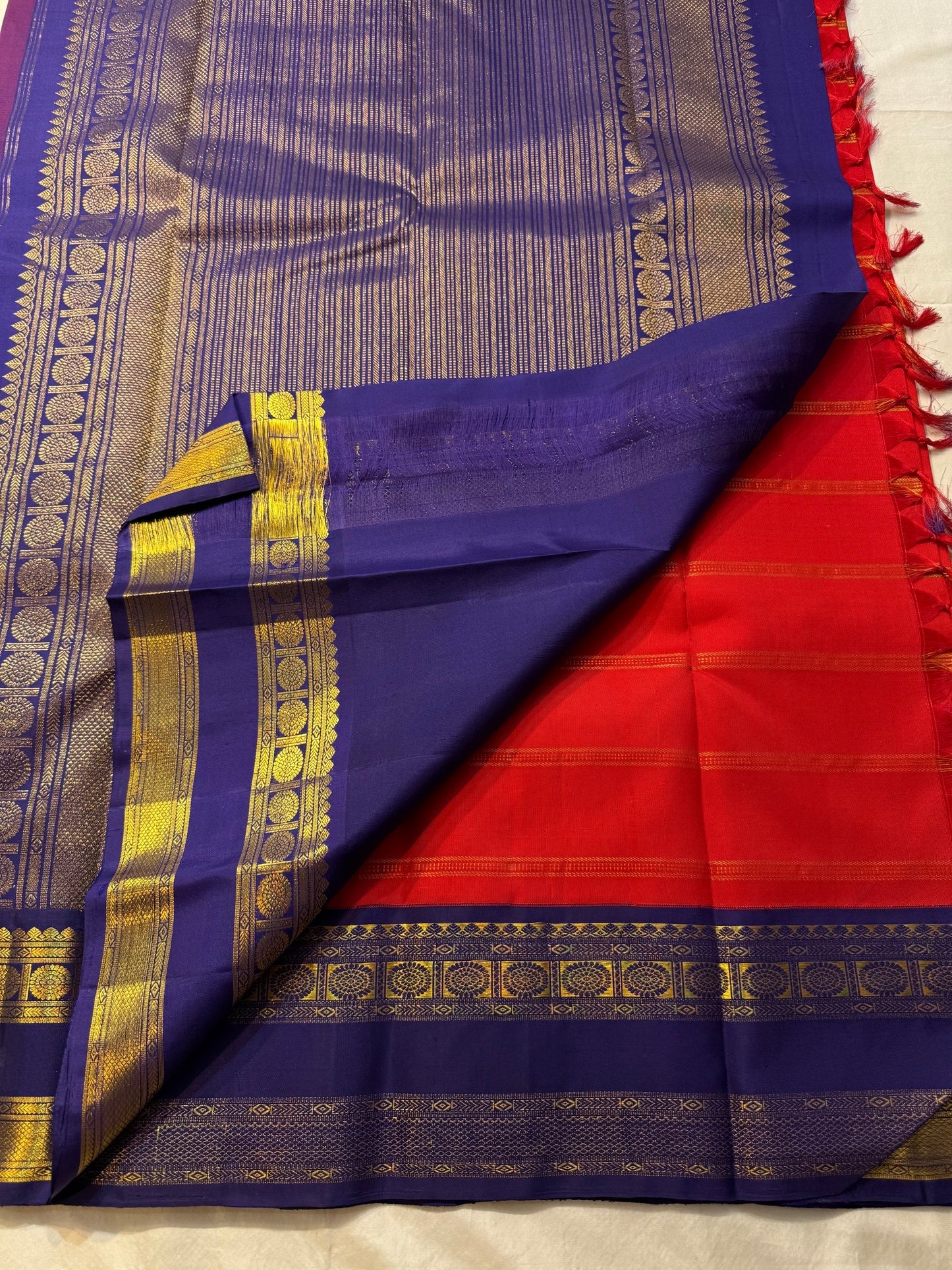 Traditional red Kanchipuram silk saree with royal blue zari border