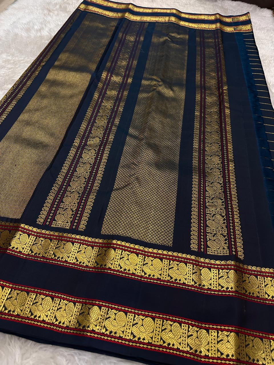 Pillar box red Kanchi Pattu saree, Veldhari gold zari stripe detail