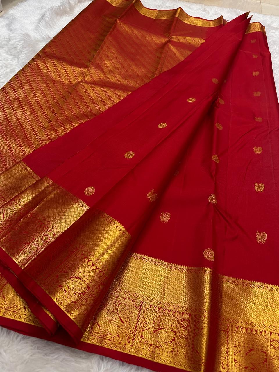 Gold zari mayil chakram roundel detail on red body