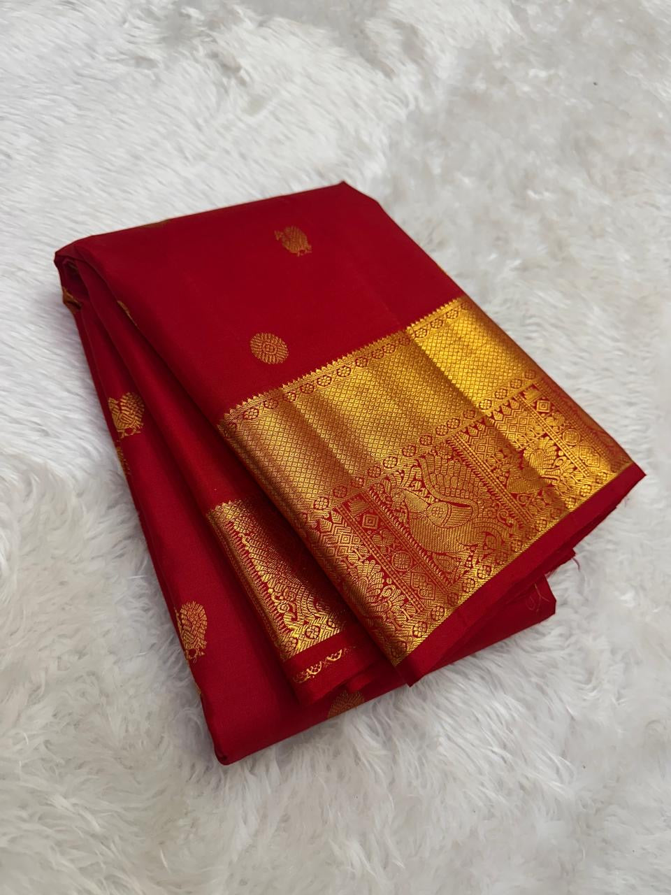 Wide gold zari peacock-and-bird border close-up