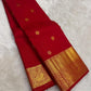 Gold zari peacock-and-bird pallu detail on red saree