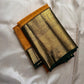 Folded Pure Kanchipuram silk saree in mustard yellow with dark green and zari woven gold border.