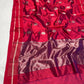 Close view of Raspberry Red Chanderi saree showing silver round floral motifs with deep green stems and leaves