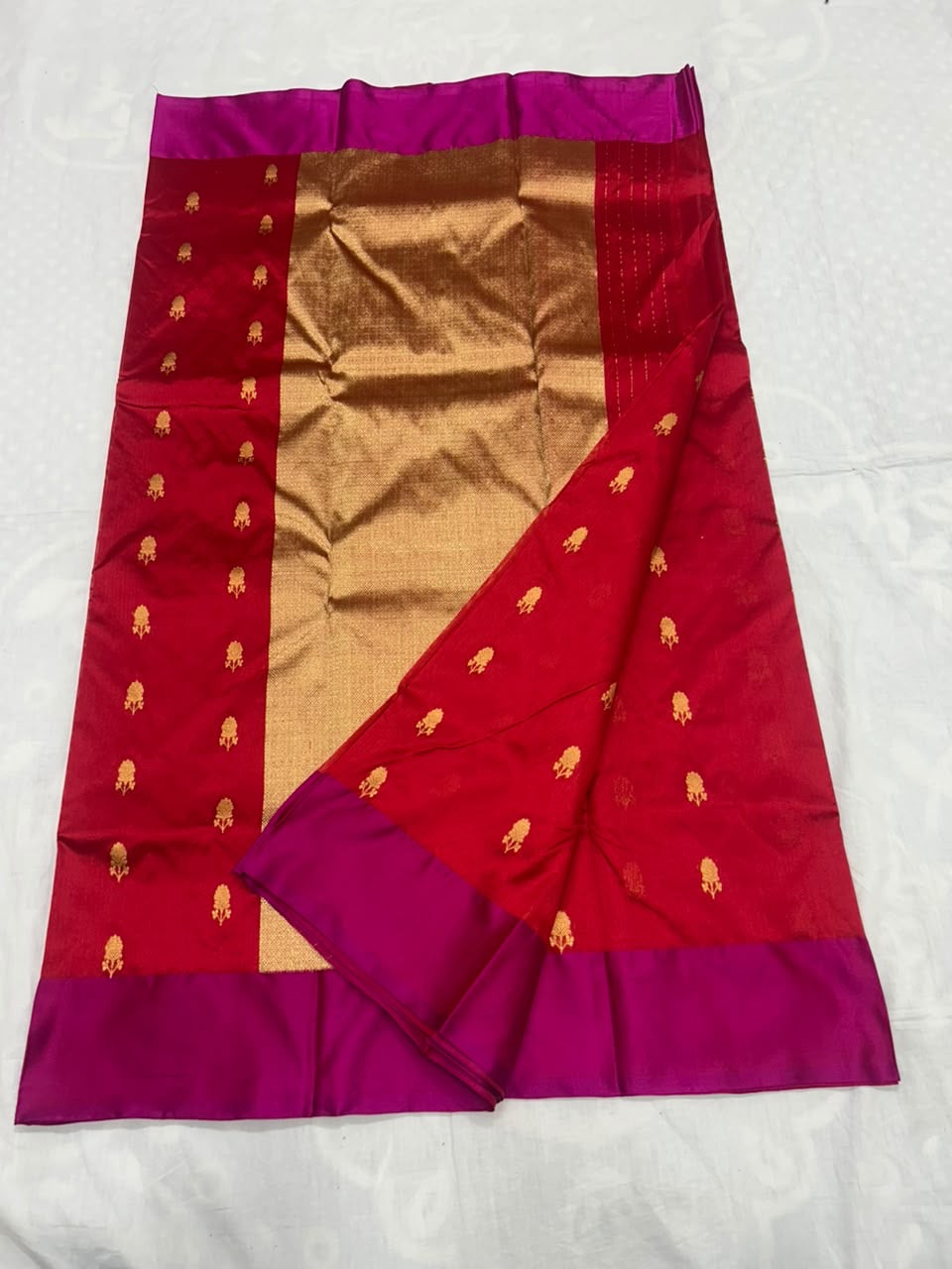 Small gold-toned buttas on crimson silk