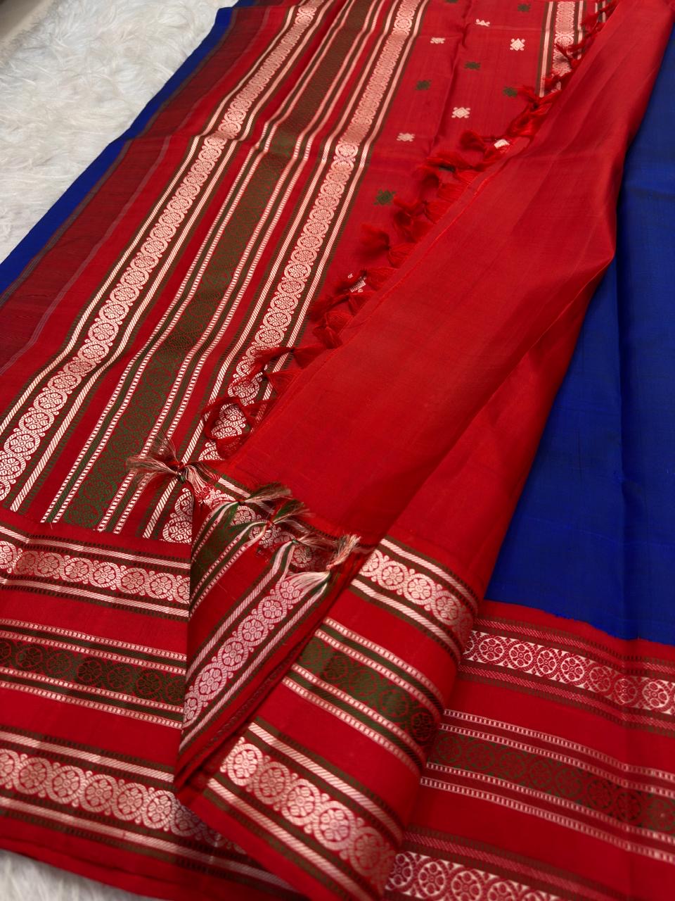 Vermilion red Pattupet border with repeated pale silk-thread Kamalam flowers and fine decorative stripes