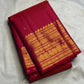Close view of needle-fine gold Vairaoosi lines across vivid red-pink pure silk.