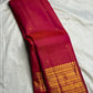 Red-Pink Vairaoosi Kanchipuram silk with small spaced gold zari buttas.